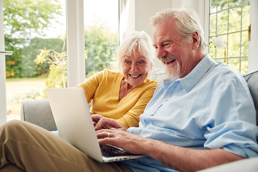 Image of Older Couple on the Sofa Looking at a Laptop